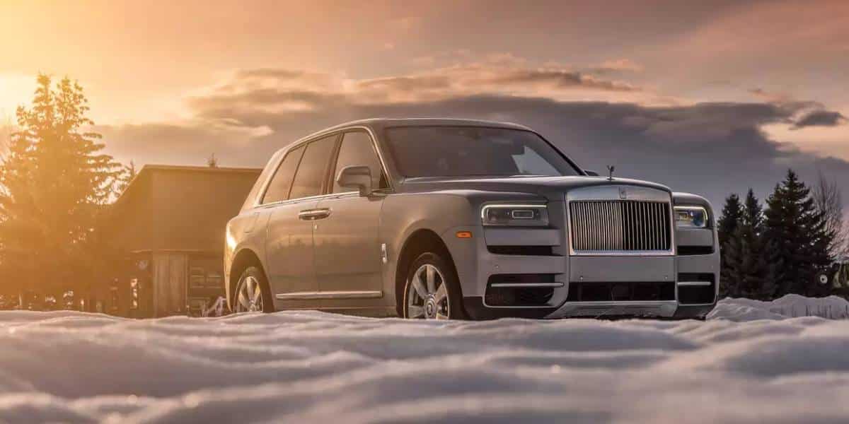 rolls royce cullinan black badge parked on snow.