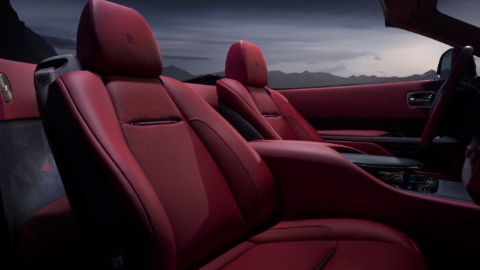 interior view of the driver and passenger seat of the rolls royce drop tail rose noir in red