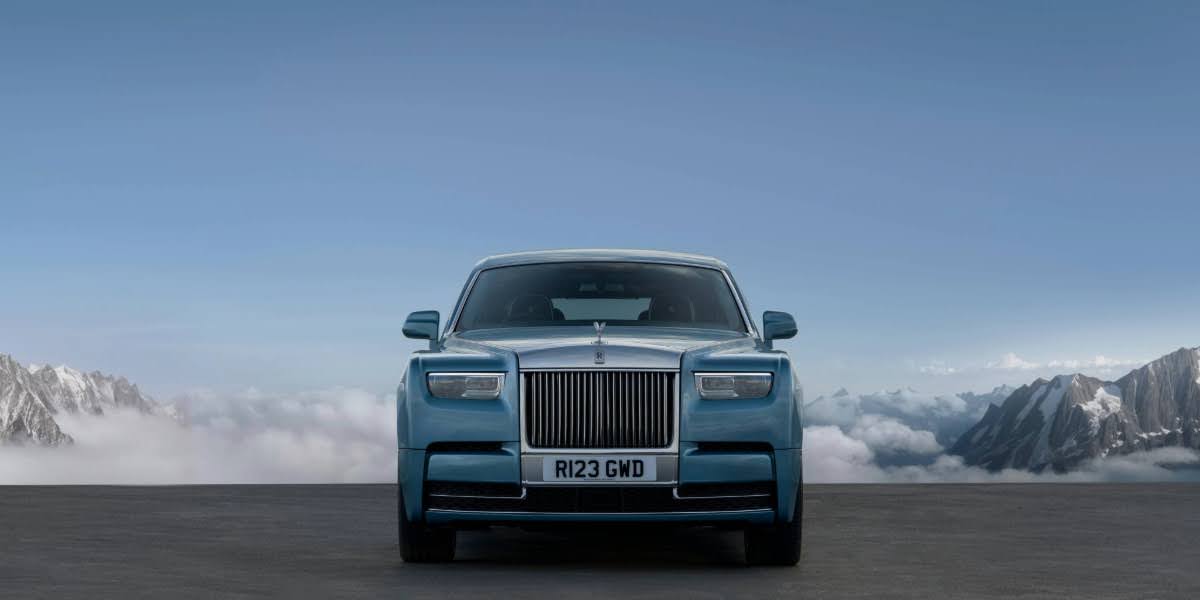 Front view of a 2025 Rolls-Royce Phantom parked in a mountain setting, showcasing elite styling that reflects rolls-royce price status.
