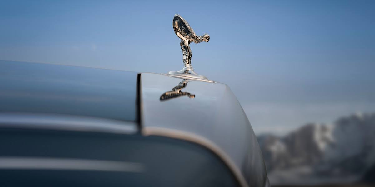 Close-up of the Spirit of Ecstasy ornament on a Rolls-Royce Phantom hood, representing bespoke craftsmanship tied to rolls-royce price.