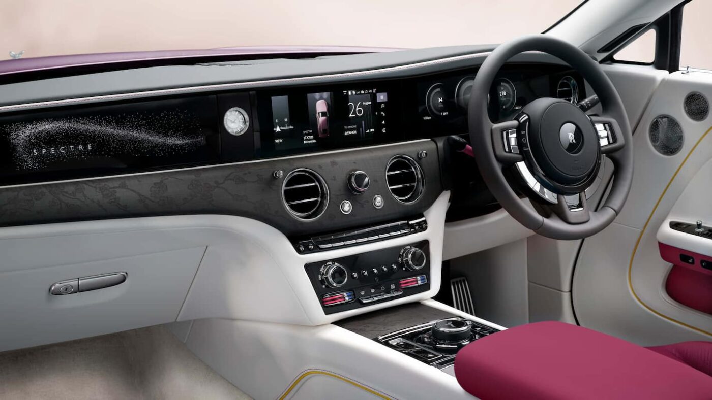 Luxurious interior of the Rolls-Royce Spectre showcasing dashboard, starlight details, and steering wheel design.