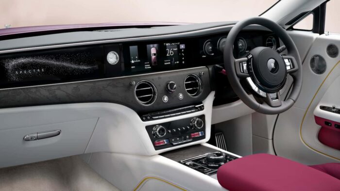 Luxurious interior of the Rolls-Royce Spectre showcasing dashboard, starlight details, and steering wheel design.