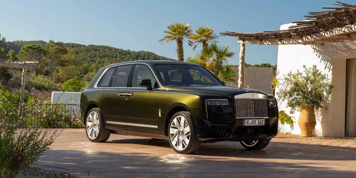 2026 Rolls Royce Cullinan luxury SUV in olive green parked at a modern villa with palm trees